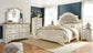 Realyn  Upholstered Panel Bed With Mirrored Dresser, Chest And Nightstand